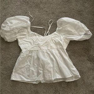 White top, flowy bottom, puffy sleeves, tight bra with two adjustable strings